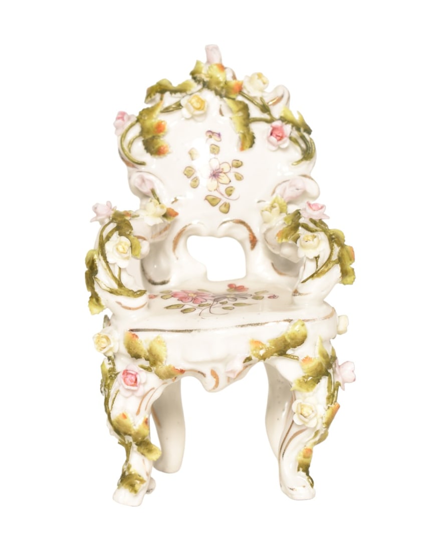 Miniature German Porcelain Chair: Porcelain chair with floral vine pattern. Marked Germany and cross lines with R to underside. 2-1/2" W x 2" D x 4-1/4" H.
