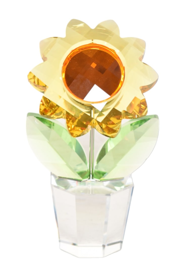 Swarovski Crystal Figurine, Sunflower in Pot: Yellow, green, and orange translucent potted sunflower figurine. Manufacturer's mark incised to underside. Designed by Keiko Arai. 4-1/2" W x 2-3/4" D x 7-3/4" H.