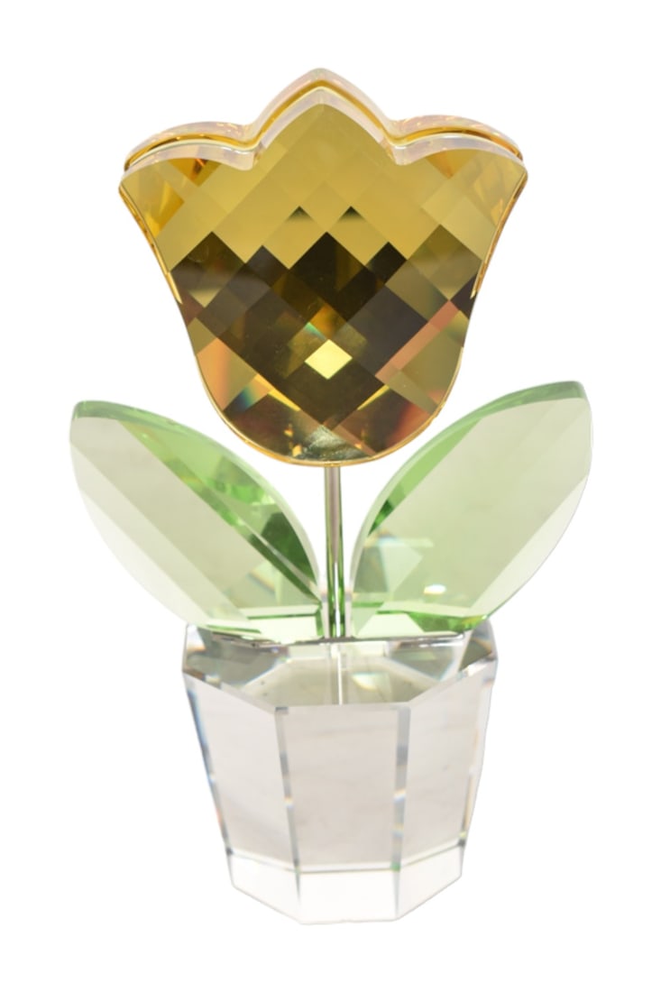 Swarovski Crystal Figurine, Tulip in Pot: Yellow and green translucent potted tulip figurine. Manufacturer's mark incised to underside. Designed by Keiko Arai. 4-3/8" W x 2-1/2" D x 7-5/8" H.