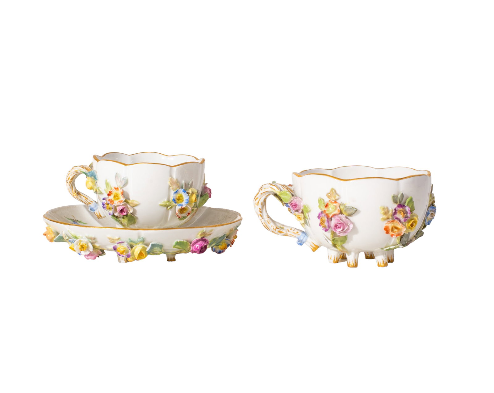 Crossed Swords Meissen Cups and Saucers: Crossed Swords Meissen Cups and Saucers. 3pc antique Meissen raised applied flowers. Manufacture's mark to underside. 1 cup- 3 3/4dia x 1 7/8h, 1 cup- 3 1/8dia x 1 3/4h, 1 saucer- 4 1/4dia x 7/8h