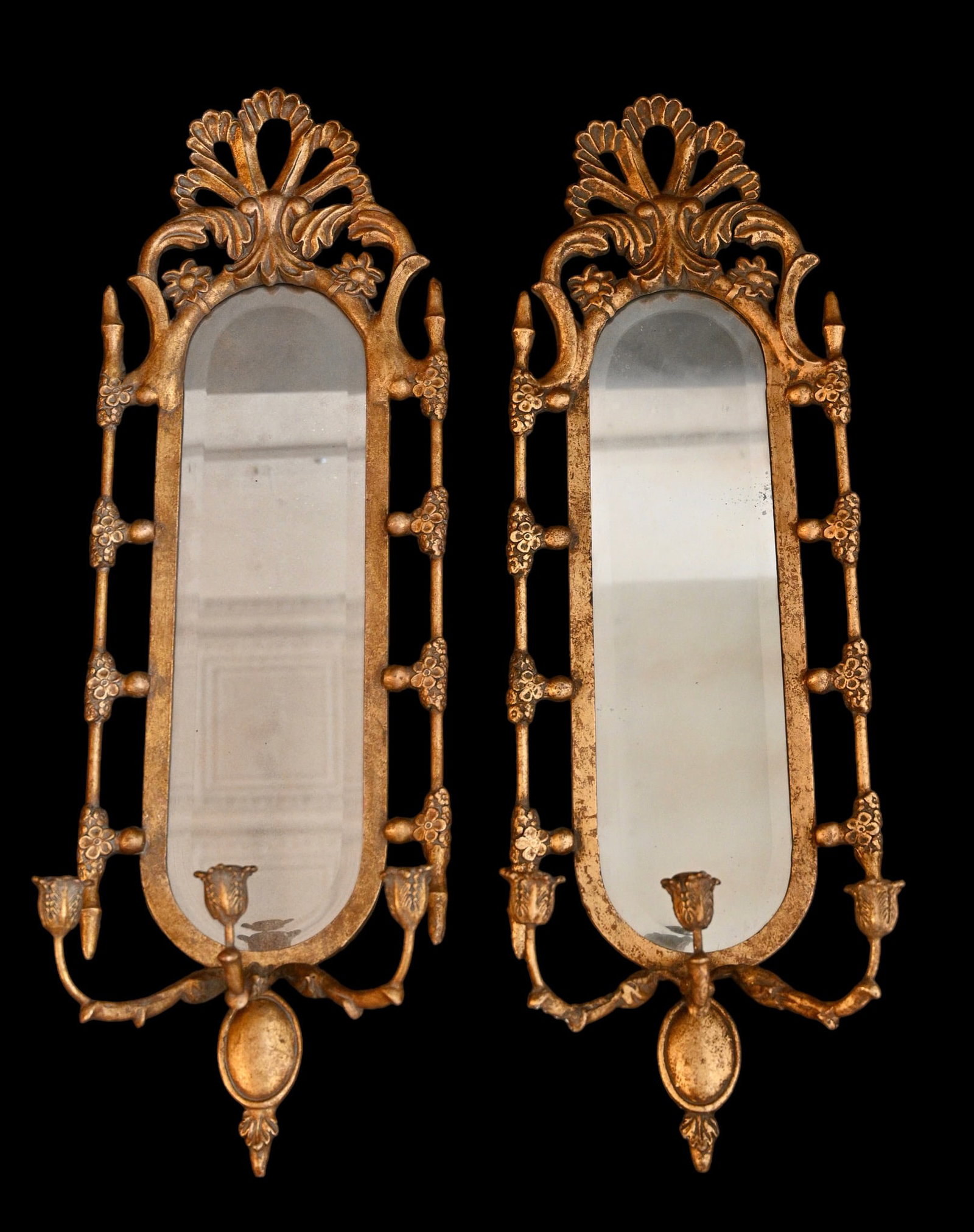 Mirrored Back Regency Style Guilt Candle Scones: Mirrored Back Regency Style Guilt Candle Scones. 20th century. Pierced center pediment over oval mirrored center flanked by acorn, floral and turned sides. 12w x 7d x 36 1/4h.