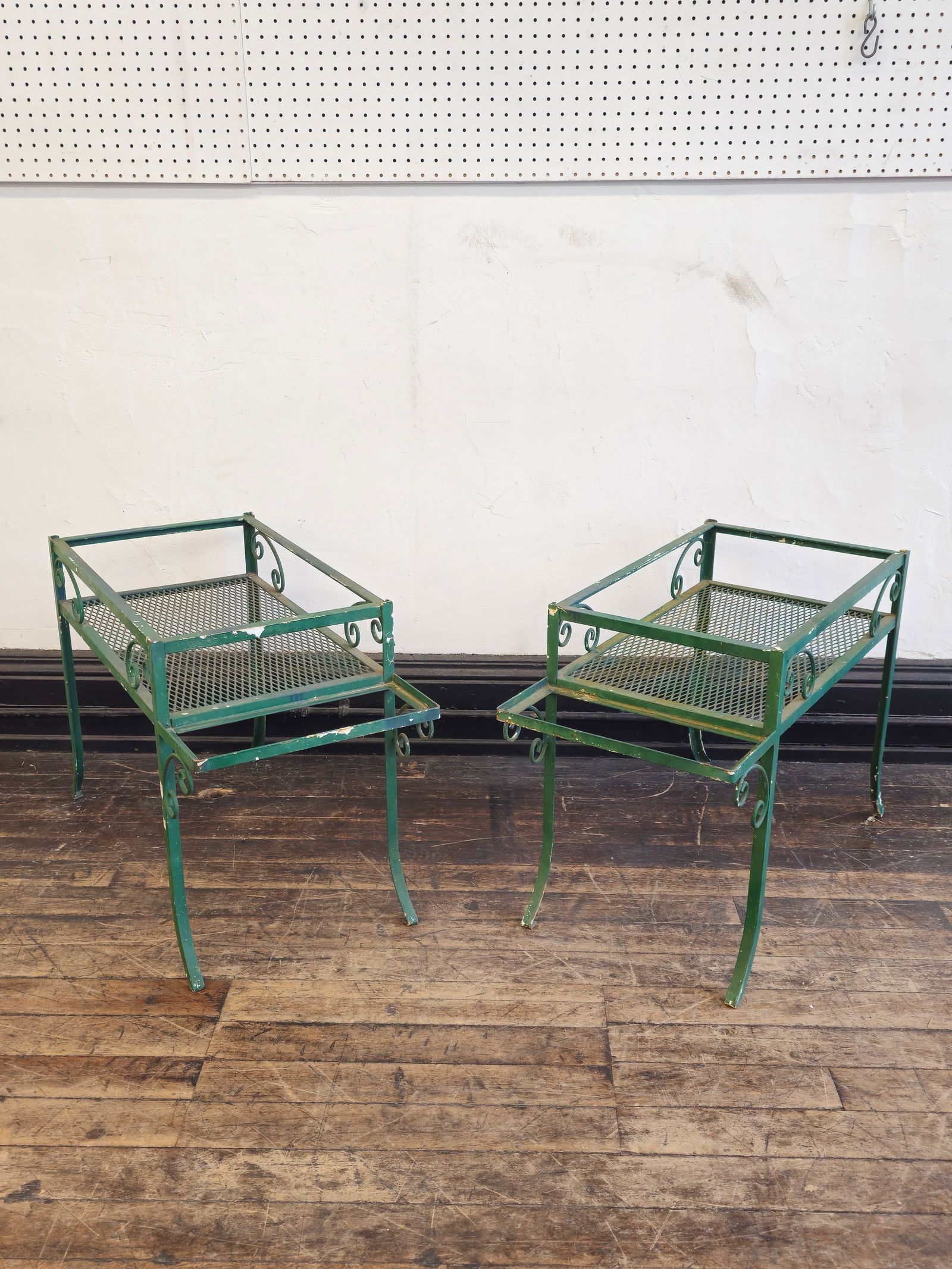 Unusual Wrought Iron Occasional Tables: Unusual Wrought Iron Occasional Tables. Pair. USA. 1960s. Wrought iron with shelf and planter holder ends. 21 1/2w x 15 1/2d x 22h.