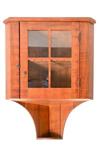 David T. Smith & Co. (Morrow, Ohio) Hanging Corner Cupboard: Hanging Corner Cupboard. By David T. Smith & Co. Morrow Ohio. 20th century. Tiger maple and other woods. Middle shelves have notched cuts for spoons. 26w x 13 1/2d x 30h.