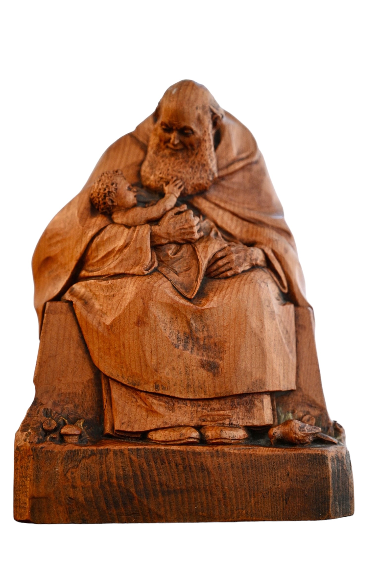 Albin Pitscheider (1877-1962) Carved Sculpture: Albin Pitscheider (1877-1962) Carved Sculpture. Carved man holding baby raised on raised base with carved animals and mushrooms. Signed on left side of base. 6w x 4 1/2d x 8h.