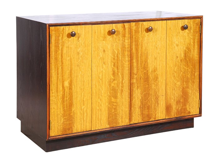 Edward Wormley Cabinet: Handsome Dunbar Server in rosewood and English oak in original finish. Two bi-fold doors with bronze circular pulls, two drawers and two shelves with original label. Purchased from Alexander Patterson