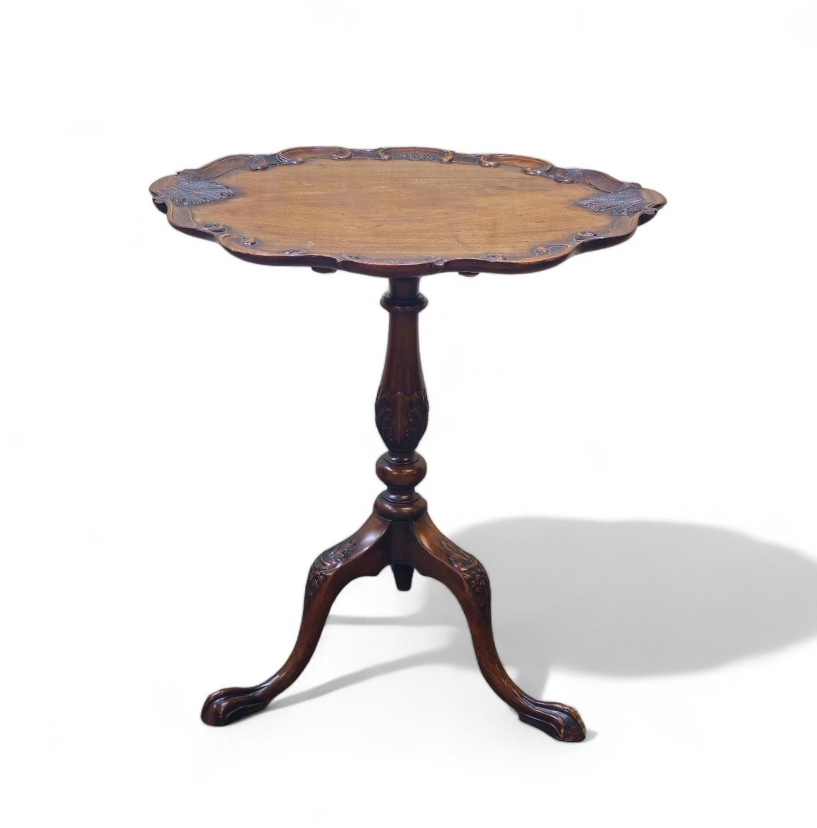 Centennial Queen Ann Style Tilt Top Table: Centennial Queen Ann Style Tilt Top Table. Scalloped molded oblong tilt top with embossed shells. Top rests on turned shaft with cabriole legs and Queen Ann claw feet. 26w x 21 3/4d x 27 3/4h. Upright