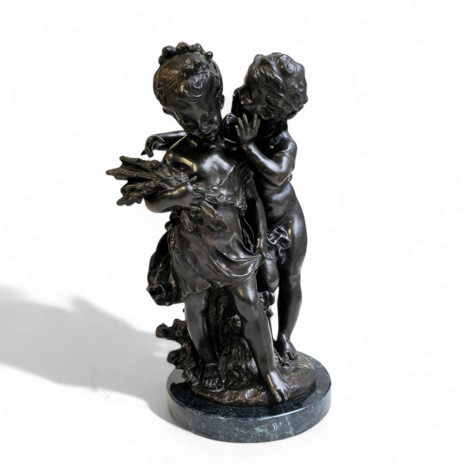 After Auguste Moreau (1834-1917)(France) Bronze Sculpture "The Secret": Bronze sculpture "The Secret" round green marble base. Stamped signature to base. French foundry seal to round disk to base. 10 1/2w x 11d x 17 1/2h