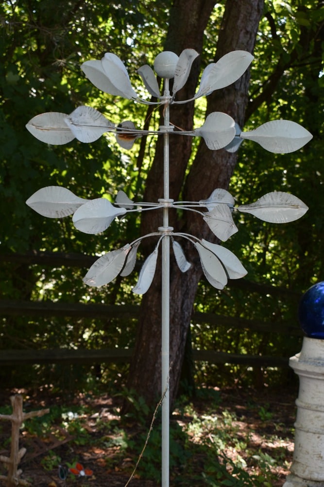 Spinning Leaves Garden Sculpture: Spinning Leaves Garden Sculpture. Original grey color. Sphere center finial. 29 1/4w x 23d x 80h.