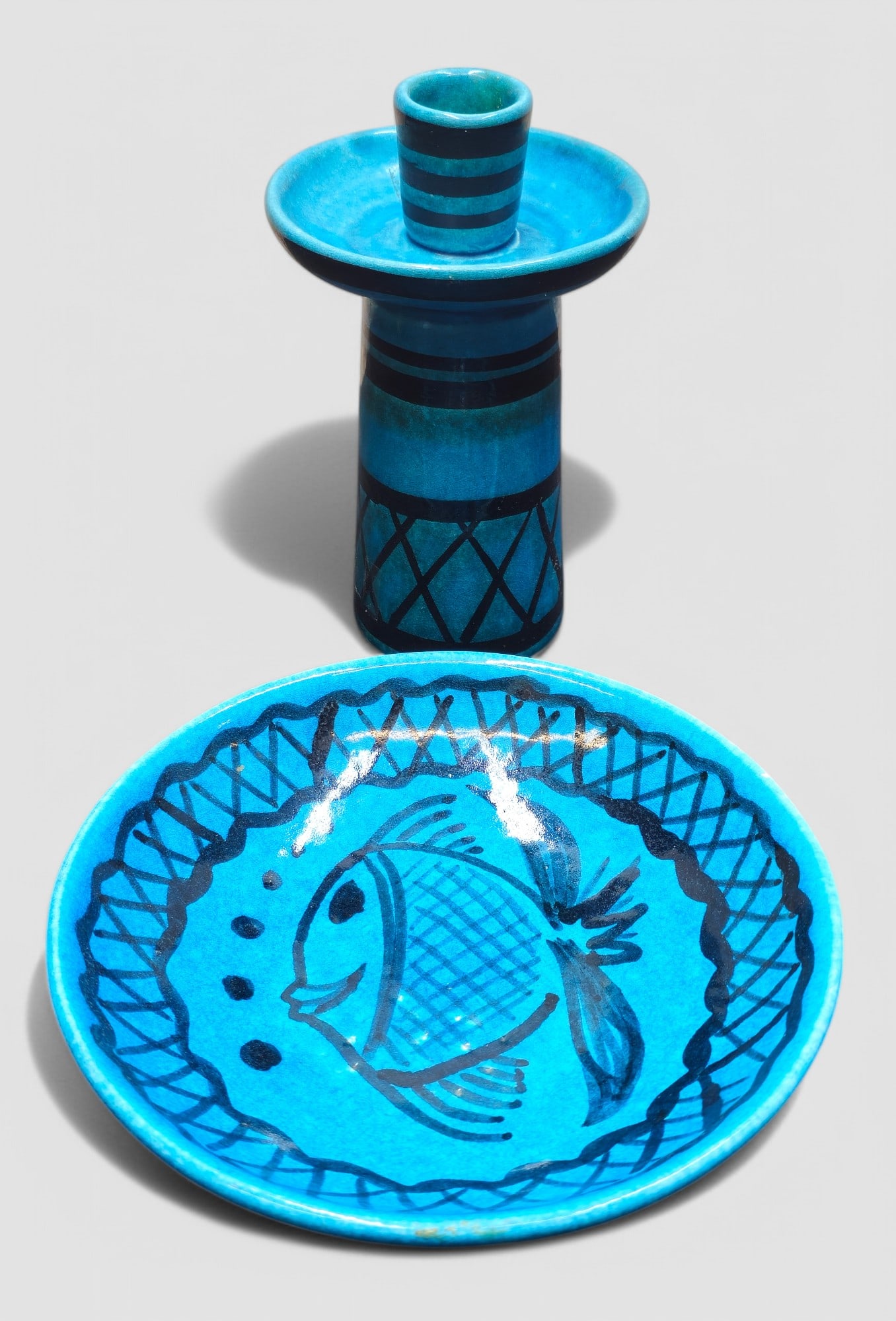 Hoffman Pottery Blue Fish Dish & Candlestick: Hand crafted blue dish and candlestick. Dish decorated with fish, both are signed "Handcrafted by Hoffman" to underside. Dish- 7"dia x 1 1/4"h. Candlestand- 4"dia x 6 3/8"h.