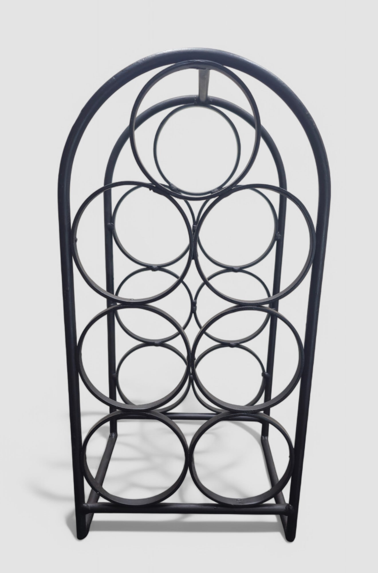 Vintage MCM Arthur Umanoff Iron Wine Rack: Iron (7) bottle wine rack by Arthur Umanoff for Shaver Howard circa 1960's. Circular iron bottle holders welded together in a arched frame. 8 5/8"w x 7 3/4"d x 17 1/4"h