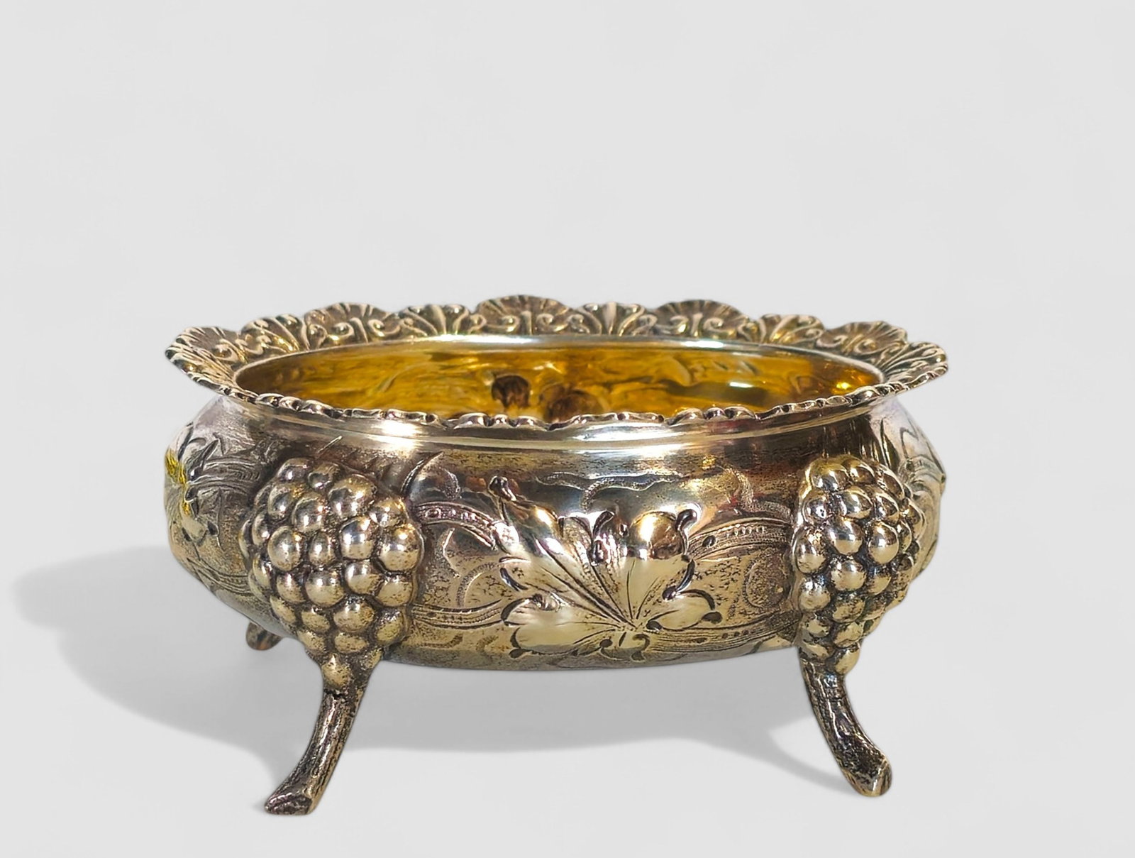Loring Andrews Sterling Repousse Grape & Floral Master Salt: Loring Andrews Sterling Repousse Grape & Floral Master Salt with scalloped oval shell border hand chased repousse with grapes and flowers. Salt rests on legs. Maker's marks to underside, sterling and 