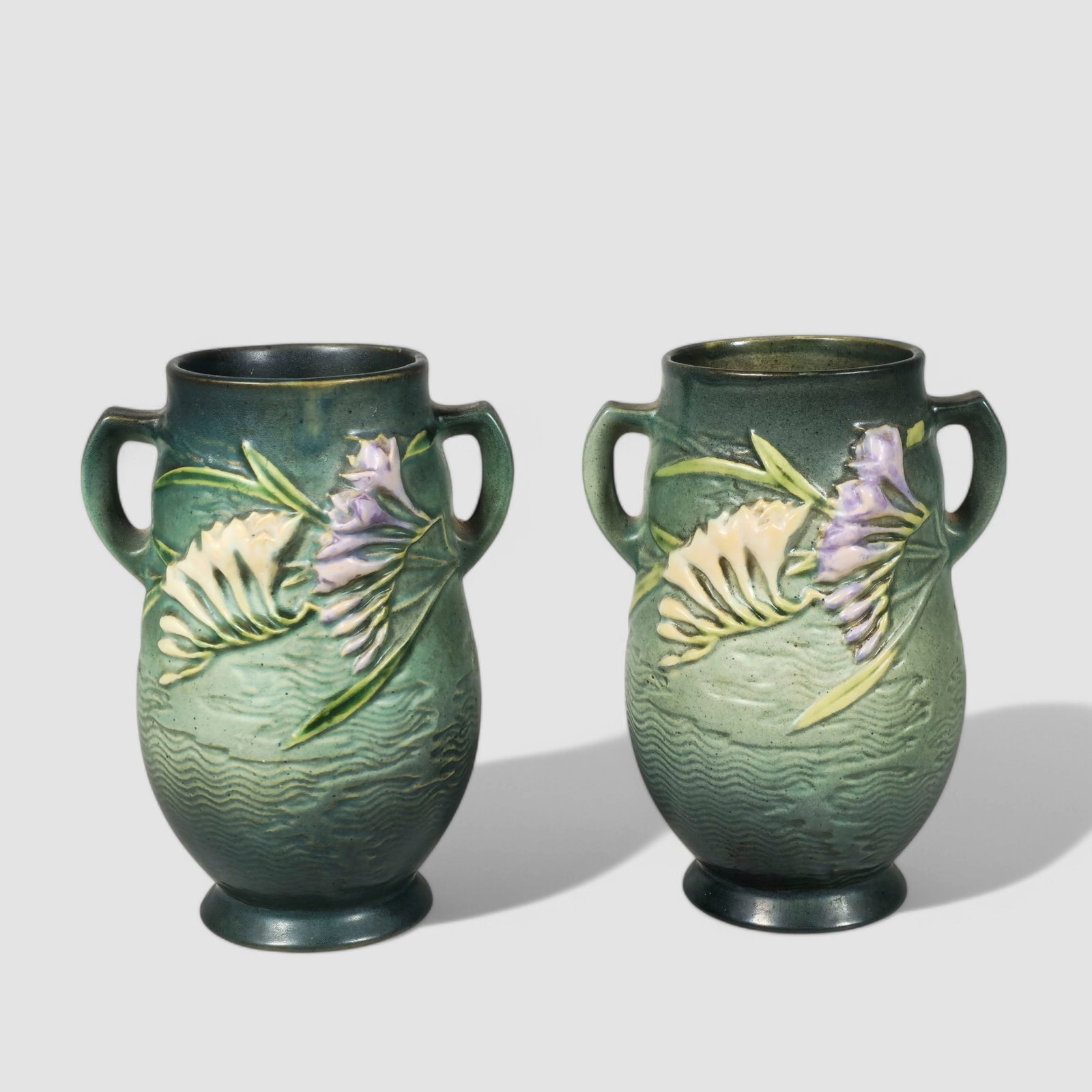 Roseville "Freesia" Art Pottery Vases #120-7: Roseville "Freesia" Art Pottery Vases #120-7, pair, circa 1945. Roseville and #120-7 to underside. 5 1/2w x 4 1/2d x 7 1/4h