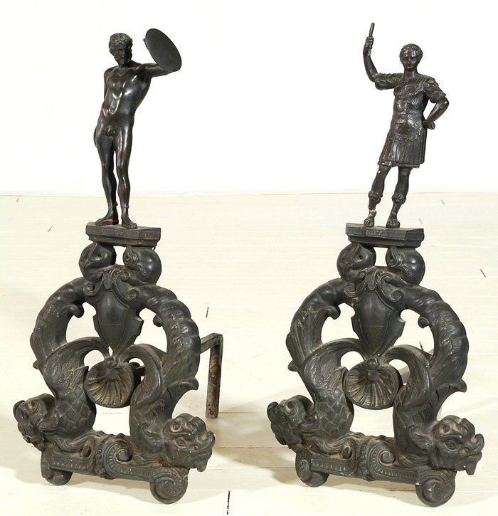 Bronze Figural Andirons: Pair of classical figures, Caesar Augustus and Breck male nude, Both supported by a pair dolphins on ornate base. 12.5W x 16D x 26H.