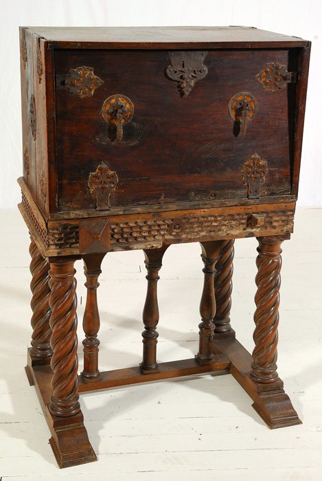 Late 17th to early 18th c Vargueno: Oak, Spanish desk on frame with drop front. Nineteen drawers, original iron hinges and hardware. Four spiral turned legs with shoe front base. Pull out slides. Size 31.75W x 24D x 51H