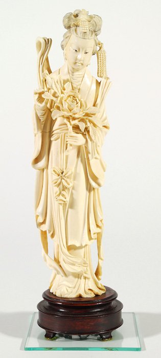 Chinese Carved Ivory Figure: Carved figure holding a rose branch in long flowing robe on teak base. Can not be shipped internationally. Size 11.5 with base.
