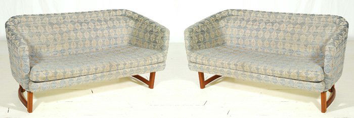 Folke Ohlsson: Pair of curved back, slender based settees. Teak legs and stretchers, original upholstery. Size 60L x 24D x 28H.