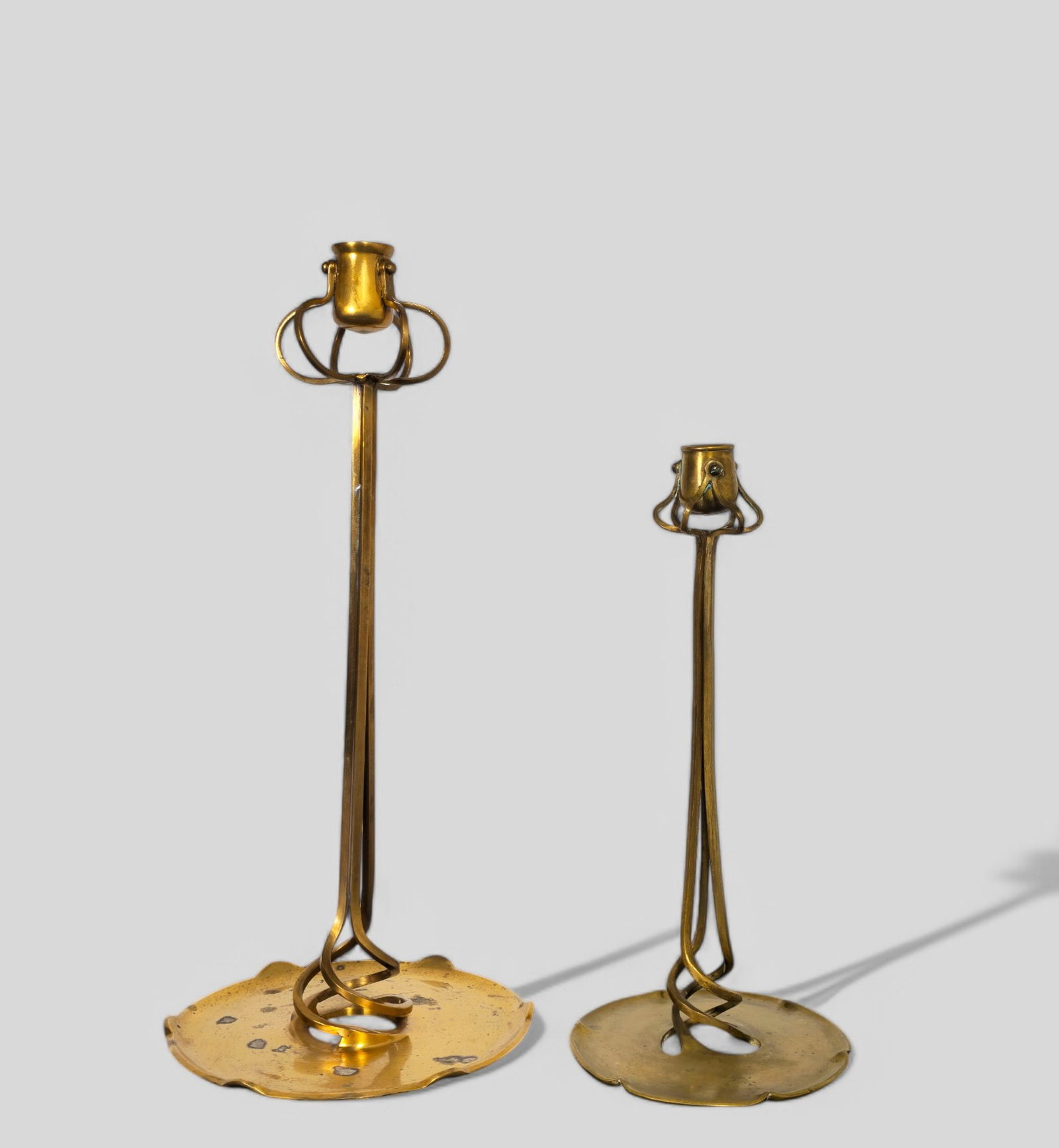 Richard Muller Candlesticks K.M. Seifert & Co.: Richard Muller Candlesticks K.M. Seifert & Co., circa 1900. Arts & Crafts candlesticks. Brass. 7 1/4dia x 16h, 5 1/2dia x 12 1/4h