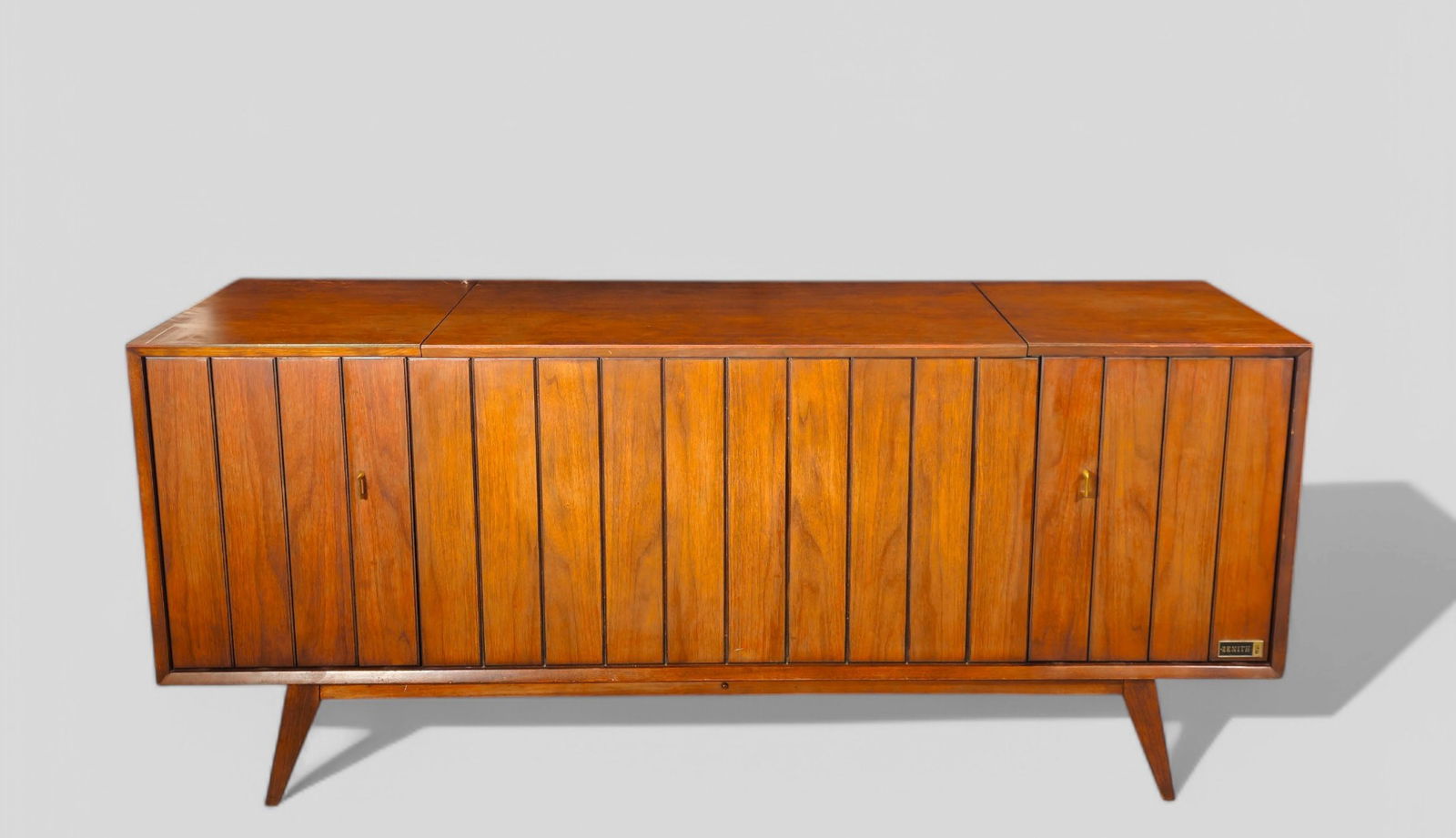 MCM Zenith X960 Console Phonograph Stereo: MCM Zenith X960 Console Phonograph Stereo. Zenith, USA, 1960's. Features, AM/FM stereo, built in speakers, turn table and record storage. Manufacturer's label to front. Walnut and brass. 64 3/4w x 20d