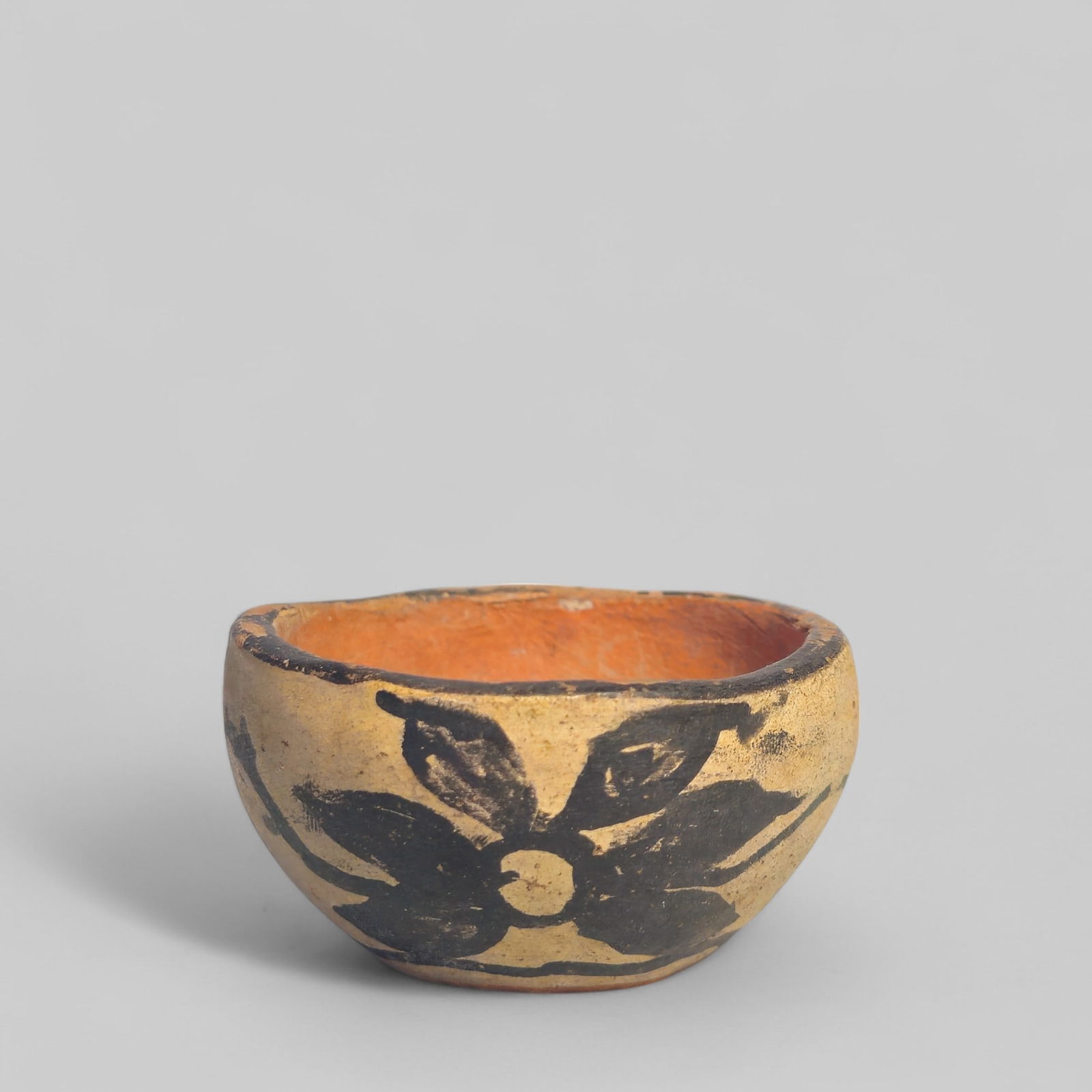 Santa Domingo Native American Pottery Bowl: 20th century Santa Domingo Native American pottery bowl. Hand coiled and painted locally sourced clay. Likely from the Kewa Pueblo region in New Mexico. 2 3/8dia x 1 1/4h