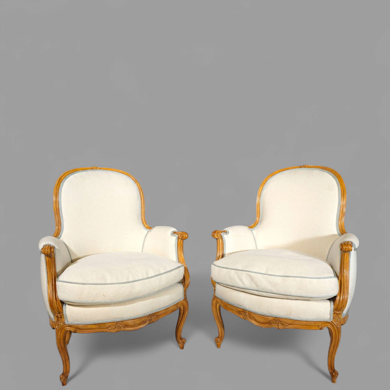 Louis XV Style French Bergere's Lounge Chairs: Louis XV Style French Bergere's Lounge Chairs, 20th century. Sculptured open back frames with silk upholstery, molded and fluted frames resting on cabriole legs, carved knees and French feet. 27 1/2w