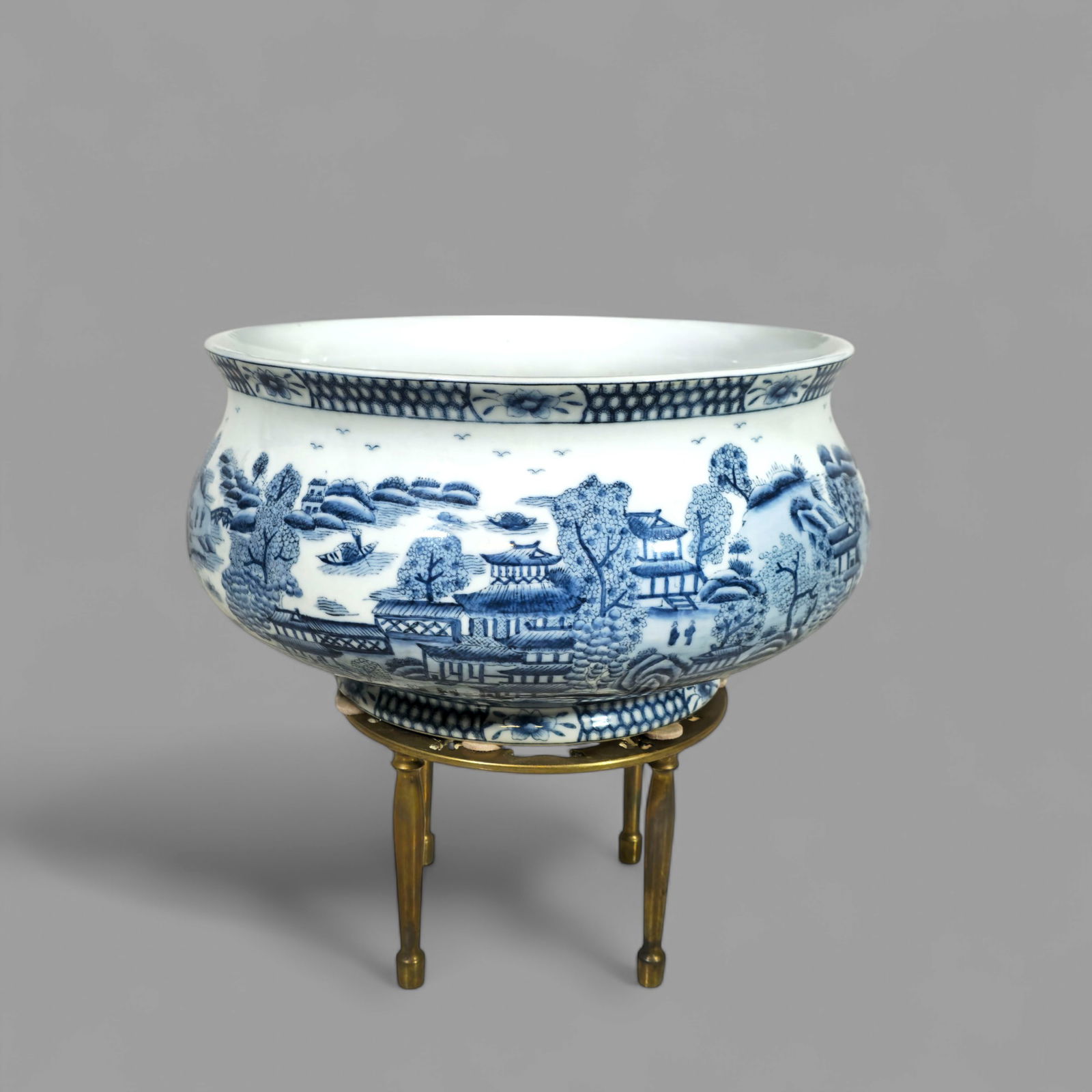 Chinese Export Porcelain Bowl and Brass Shamrock Trivet: Chinese Export Porcelain Bowl and Brass Shamrock Trivet. Bowl has flared rim and decorated with water wags, landscapes, structures and figures. Interior is decorated with structures in mountains. Bowl