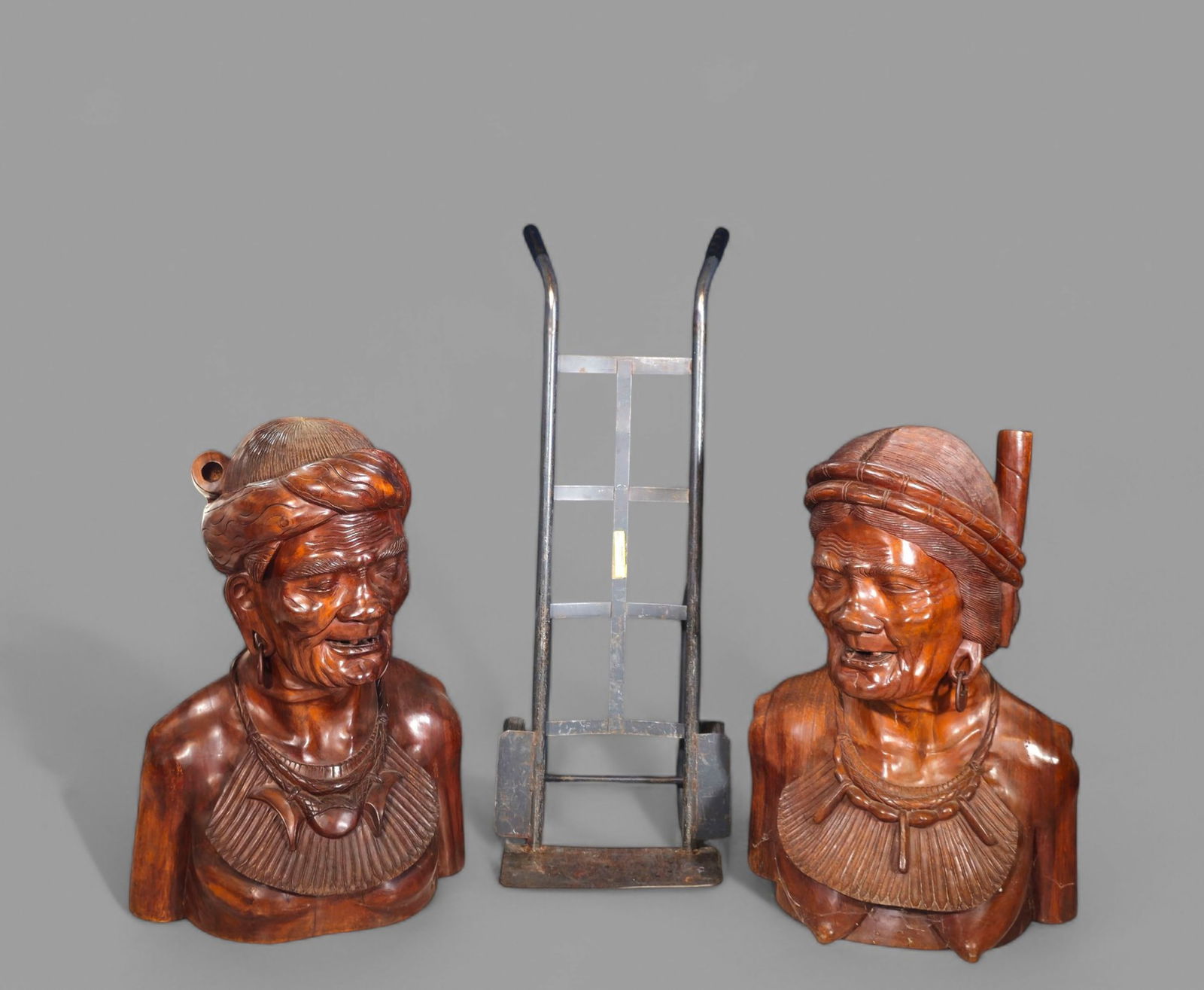 Monumental Teak Floor Busts of Tribal Heads: Monumental Teak Floor Busts of Tribal Heads, man and woman, 1960's. Solid teak. PLEASE NOTE SIZE - 24w x 21d x 38h