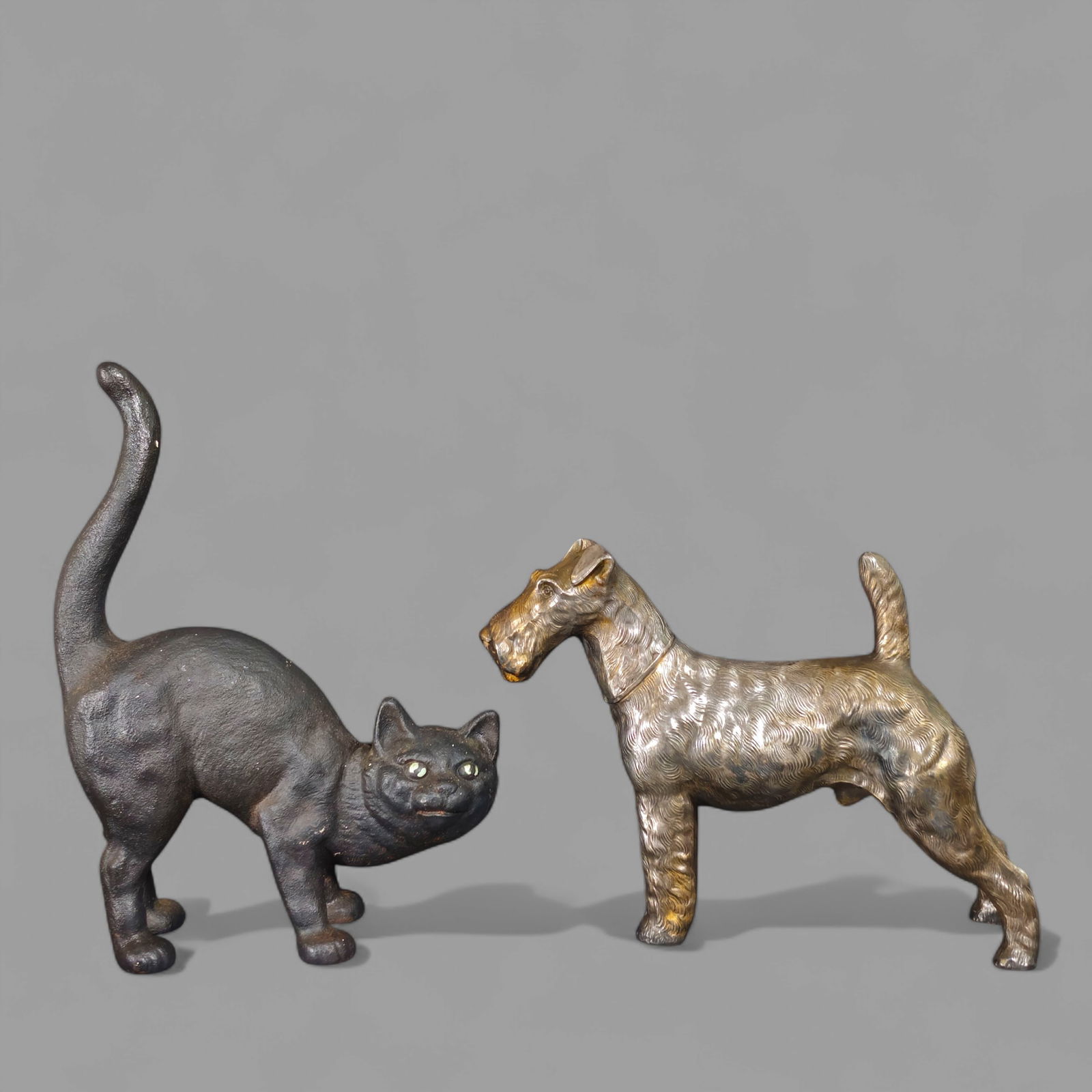 Schnauzer Scottish Terrier & Black Cat Door Stops: Schnauzer Scottish Terrier & Black Cat Door Stops. Schnauzer is brass plated metal. Black cast iron cat door stop. Cat- 3 1/2d x 10 1/2h Dog- 9 1/2w x 3d x 7 1/4h