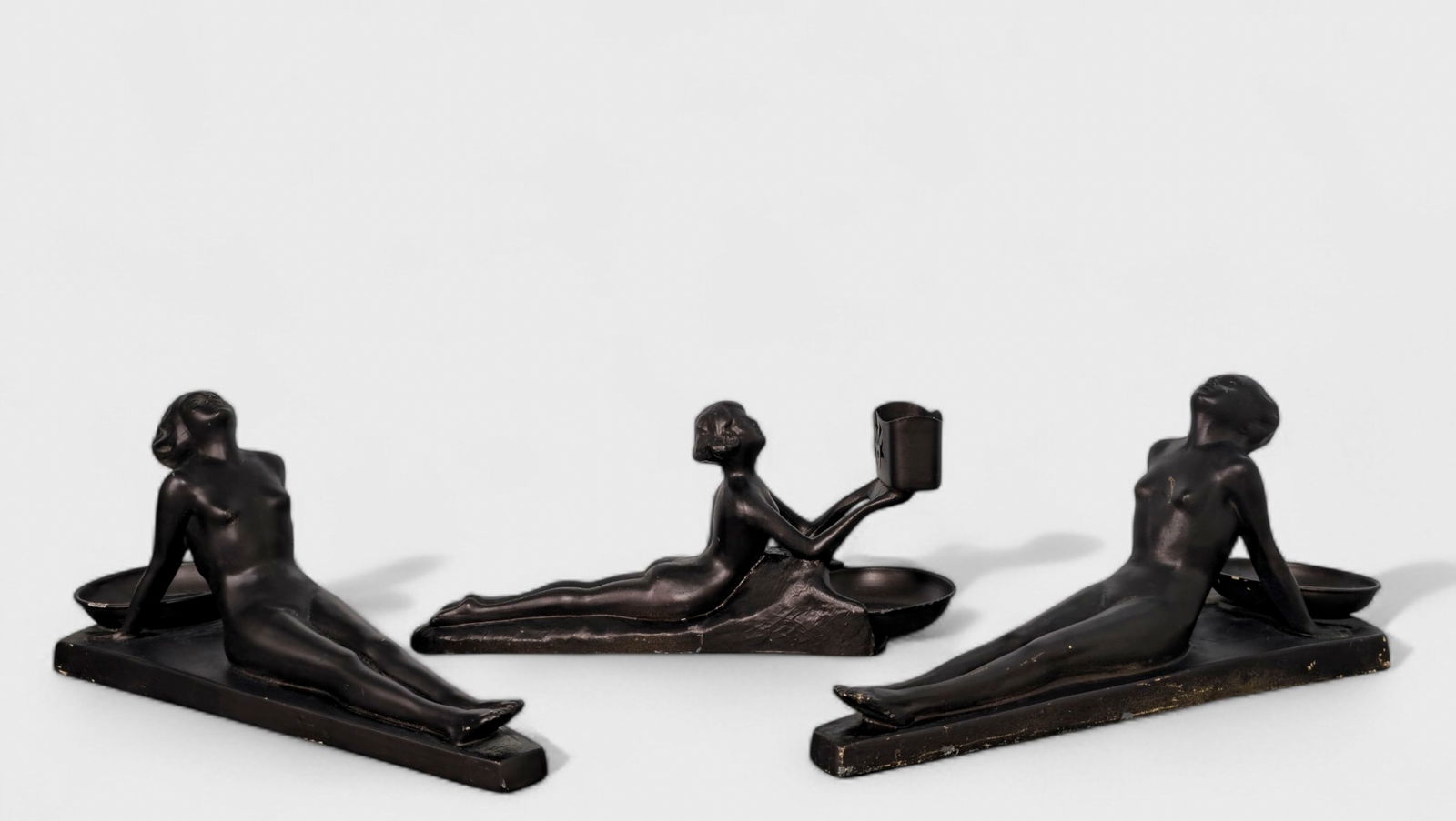 Art Deco Ronson Nude Smoker's Set: Art Deco Ronson Nude Smoker's Set, USA, 1920's, (3) total. Pair of nude reclining ladies and one laying nude with match holder. Patinated metal. 12 1/2w x 4 3/4d x 5 1/2h
