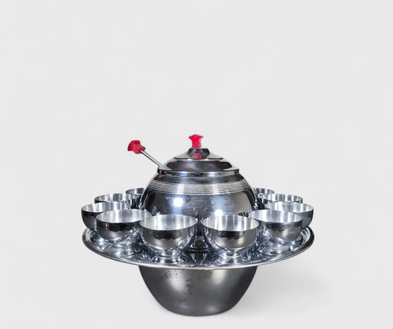 Art Deco "Saturn" Punch Bowl with Chase "Gaiety" Cups: Art Deco "Saturn" Punch Bowl with Chase "Gaiety" Cups. Punch bowl circa 1937. Chase cups, USA. 1934. Each element is marked. Punch bowl is complete. Chrome plated metal and red acrylic. 14 3/4dia x 10
