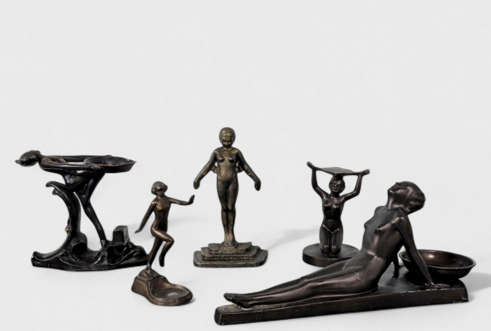 Assembled Art Deco Lady Grouping: Assembled Art Deco Lady Grouping, (5) total pieces. Standing reclining lady with bowl, sitting nude, standing nude bookend, dancing nude lady and Frankart reclining lady with bowl. Patinated metal and