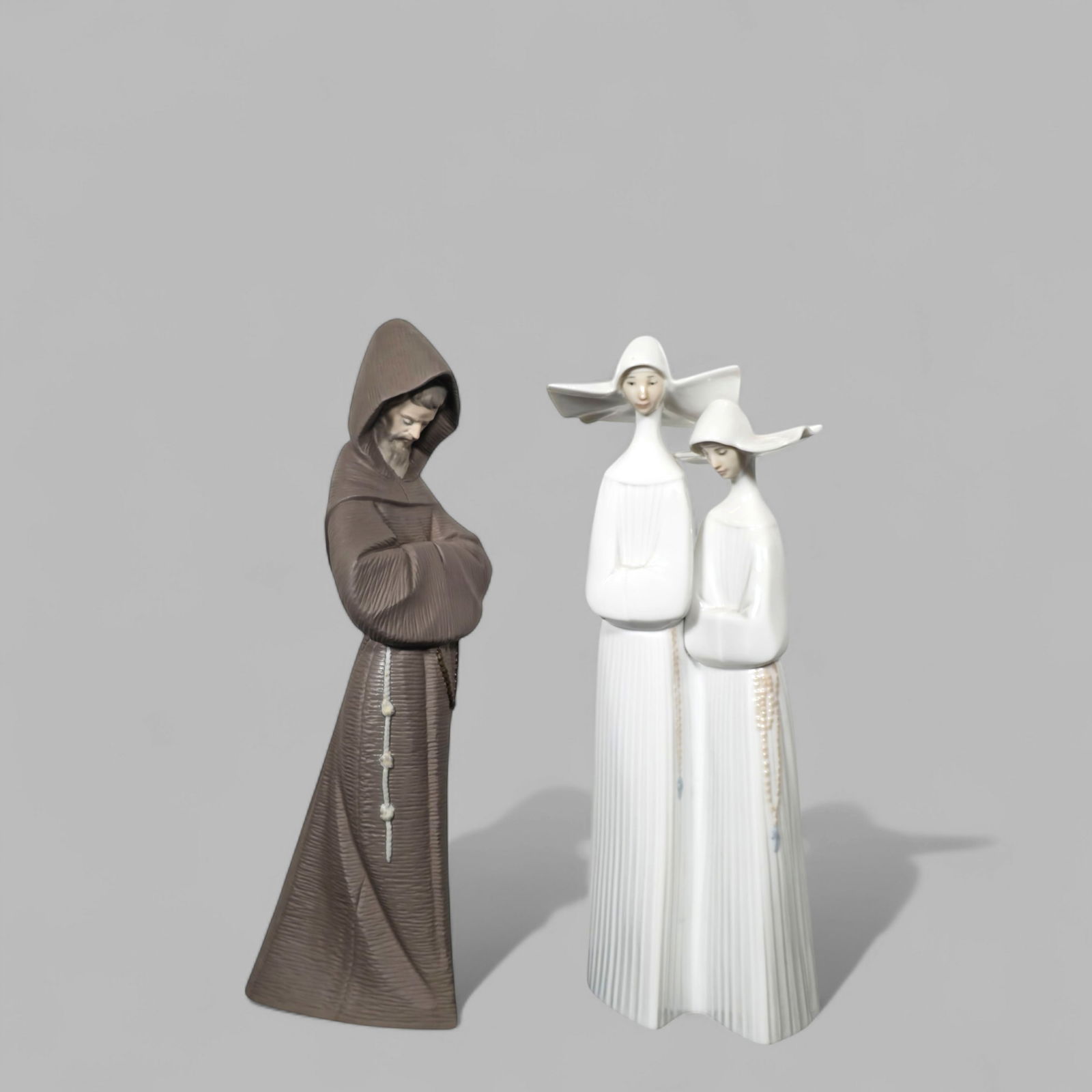 Lladro Nuns, #4611 & Monk #2060: Lladro Nuns, #4611 & Monk #2060, Spain. Glazed porcelain. Manufacturer's marks on underside. Monk- 3 1/4w x 5d x 13 1/2h.