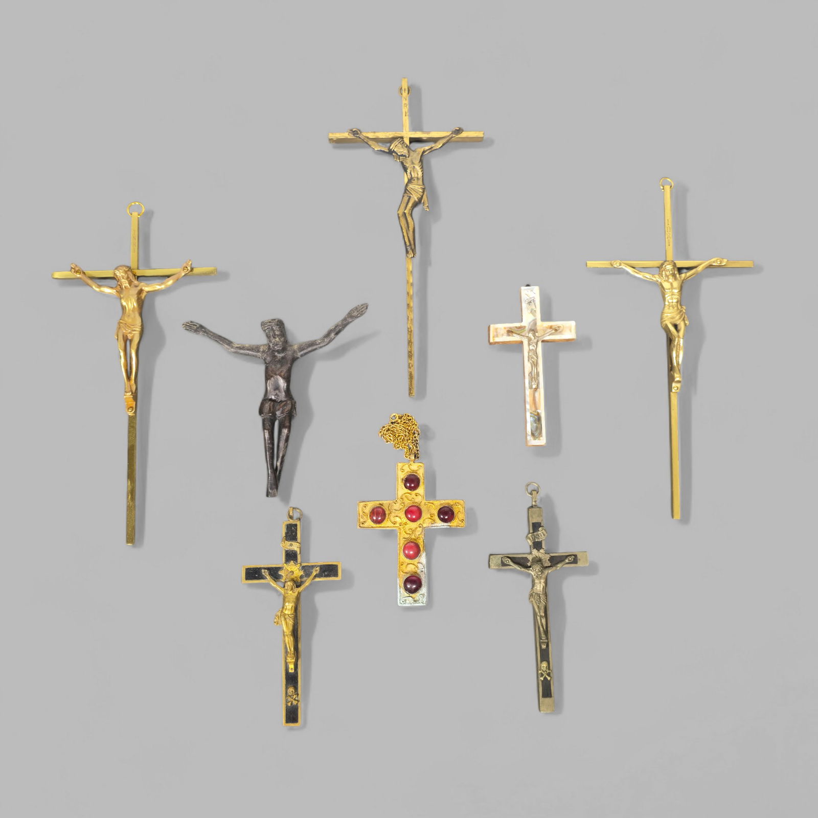 Assembled Crucifixes: Assembled Crucifixes, (8) total. (3) brass, (1) gilt bronze and ebony, (1) gilt bronze with semi-precious stones and (3) pewter. Circa 1880 - 1960s. Largest- 5w x 1/4d x 10 1/4h.