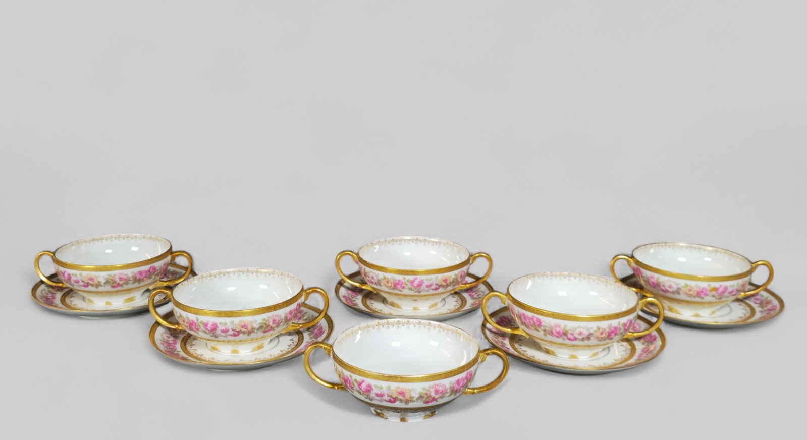 Limoges GDA Porcelain Bouillon / Soup Cups and Saucers: Limoges GDA Porcelain Bouillon / Soup Cups and Saucers. France, 1920's. 6 cups and 5 saucers. Manufacturer's marks to underside. Saucers 5 1/2 dia, Cups - 5 1/2 w x 3 7/8 d x 1 3/4 h.