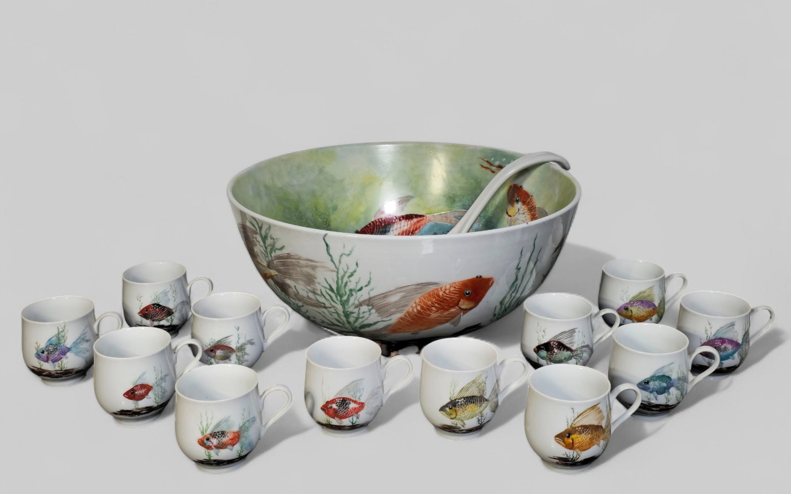 Tom Trauthwein Punch Bowl and Cups: Tom Trauthwein Punch Bowl and Cups. 20th Century. Hand painted fish and sea motif. Punch bowl, label and 12 cups. Bowl 16 Dia x 7 1/2H, cups 3 1/4H.
