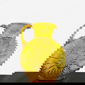 Blenko Glass Sunburst Pitcher: Mid century modern mold-blown topaz glass pitcher with pressed sunburst pattern to each side, applied handle, and hand-finished rim. Designed under Joel Myers for Blenko Glass Co., Milton, West Virgin