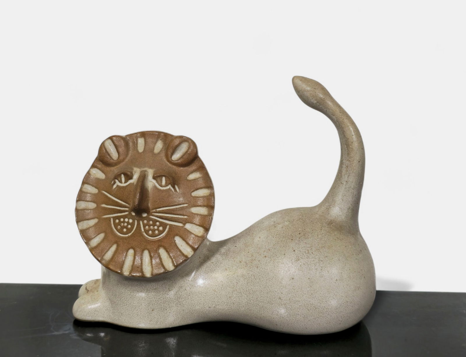 Gordon & Jane Martz Stoneware Lion: Mid-century modern stoneware lion by Gordon and Jane Martz for Marshall Studios, featuring a matte beige body with stylized face and raised tail. A charming example of the Martz Studio’s minimal
