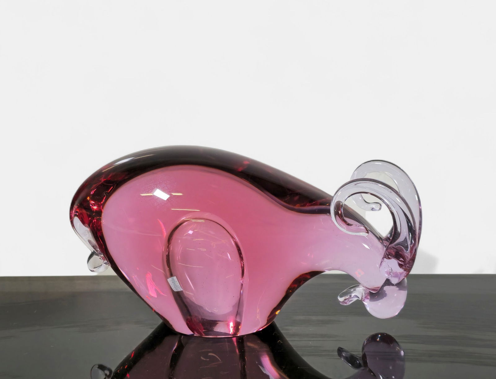 Miloslav Janku Art Glass Ram Sculpture: Art glass sculpture depicting a stylized ram in deep rose and amethyst tones. The piece showcases fluid modernist contours with clear glass horns and body shading achieved through layered color. Incis