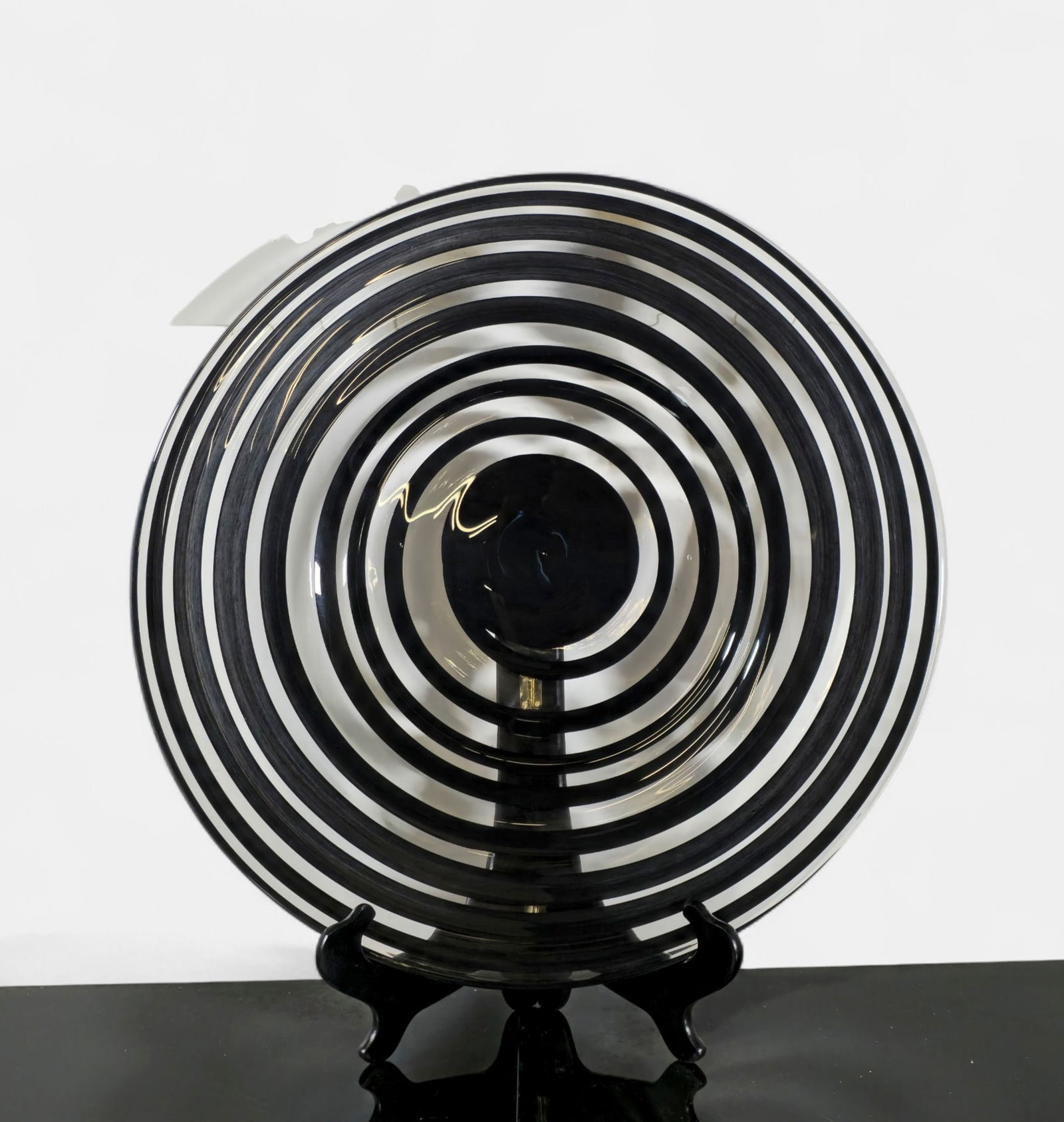 Murano Black and Clear Art Glass Charger: Striking Murano art glass charger featuring alternating black and clear concentric rings in a bold, optical pattern. Mid century modern hand-blown with smooth, shallow form and polished base and conce