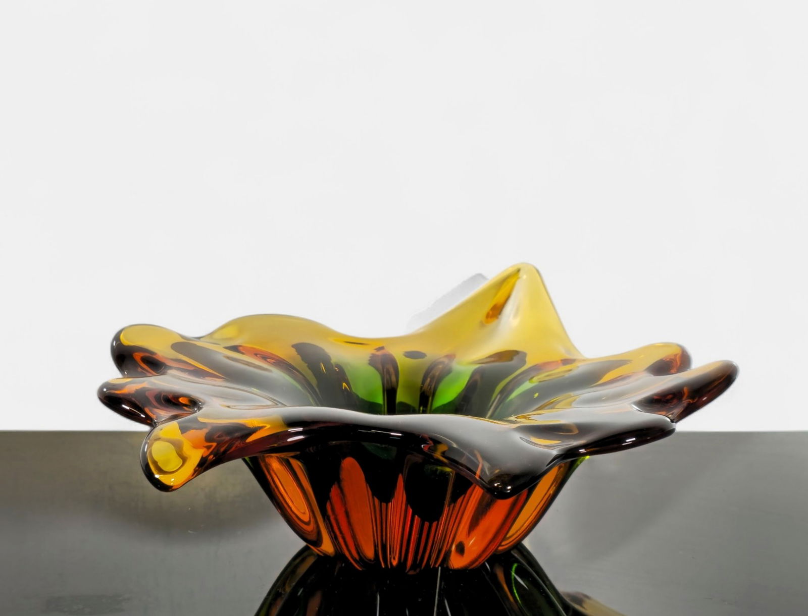 Murano Art Glass Sommerso Freeform Bowl: Mid century modern hand-blown Murano glass bowl featuring a dramatic ruffled freeform design with layered Sommerso coloration in amber, green, and clear tones. Thick-walled construction with smooth po