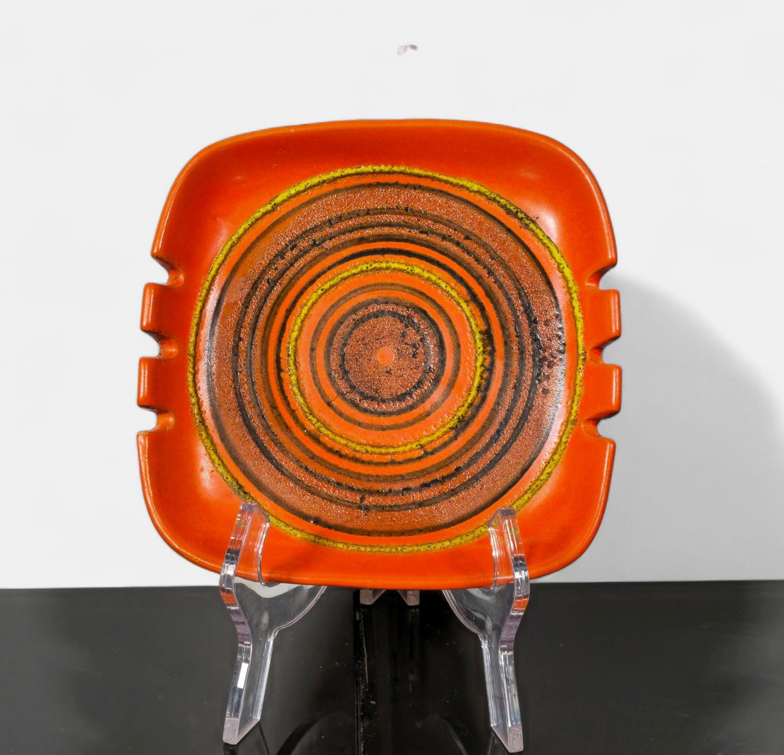 Alvino Bagni for Raymor Ceramic Dish Model R.176/10: Square ceramic dish with rounded corners and four notched edges, decorated in Alvino Bagni’s signature orange glaze with concentric incised rings in brown and yellow. Marked to underside R.176/1