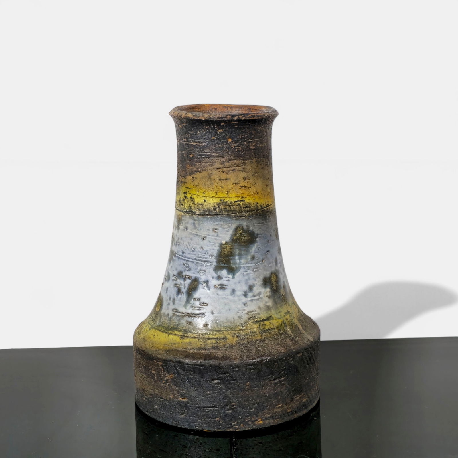 Marcello Fantoni for Raymor Glazed Earthenware Vase: Hand-thrown ceramic vase with flared neck and wide cylindrical base, finished in layered glazes of ochre yellow, slate blue, and earthy brown over a textured surface. Signed Fantoni Italy for Raymor t