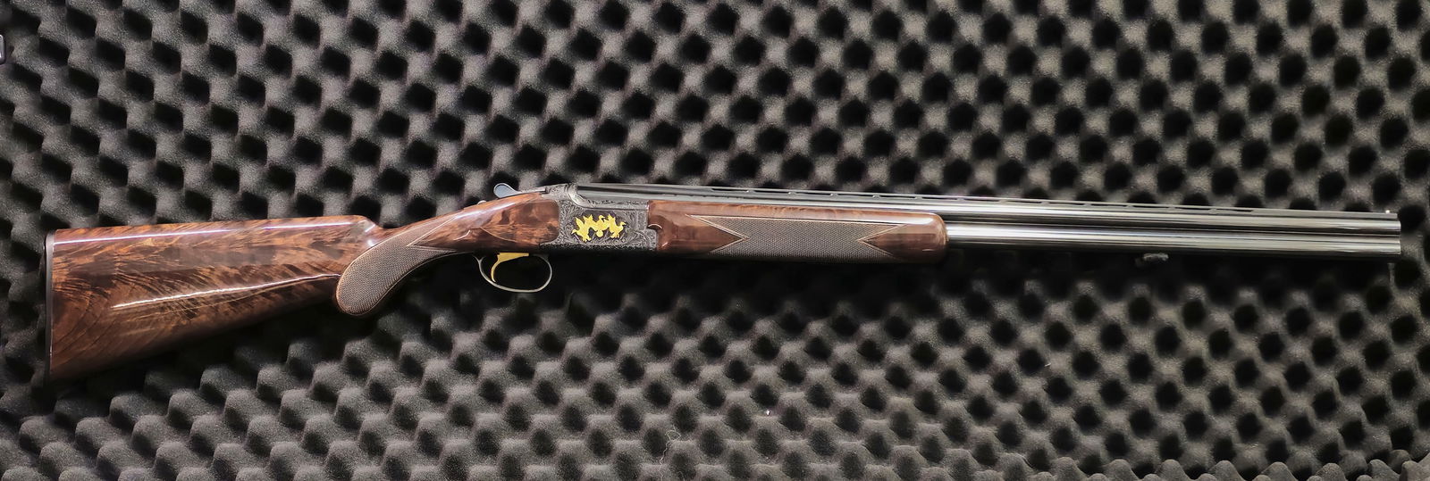 Browning Citori Lightning 20 Gauge Shotgun: Browning Citori high-grade 20 gauge over/under shotgun. SN 19714MW131. Featuring deep relief scroll engraving with three gold inlaid game birds on each side of the receiver. The action shows beautiful