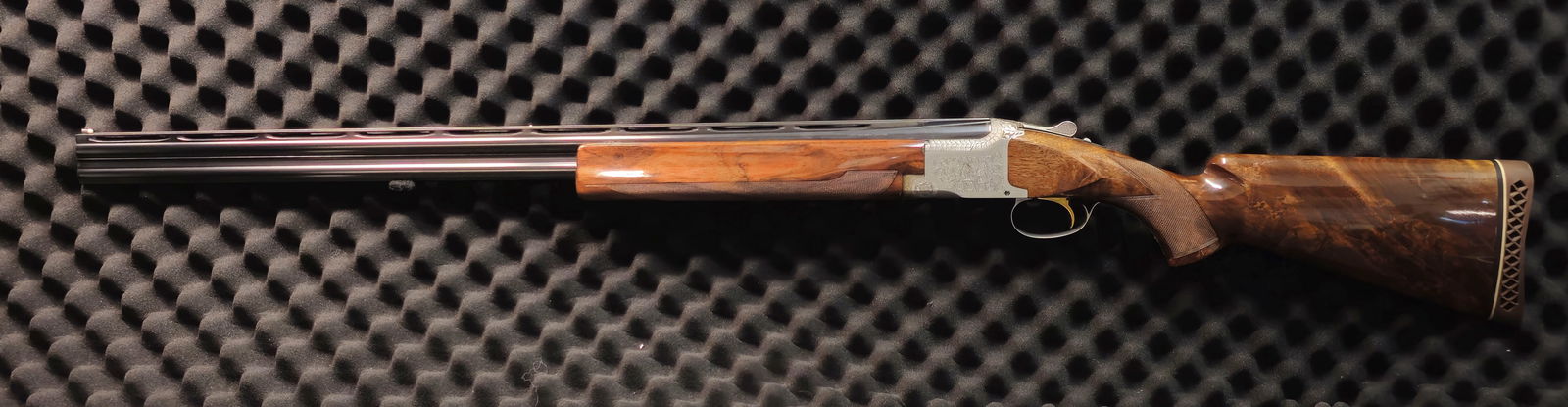 Browning Pigeon Grade 12 Gauge Over/Under Shotgun: Browning Superposed 12-gauge over/under shotgun. SN 56835S8. Made in Belgium, featuring extensive full-coverage hand engraving in deep scroll and floral patterns across the receiver, fences, tangs, an