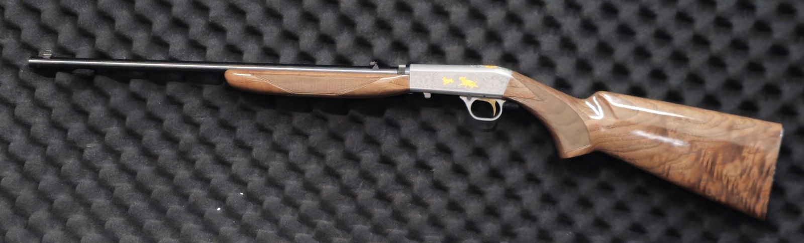 Browning SA-22 “Gold Series" Grade IV .22 LR Rifle Silver Nitride with Gold: Browning SA-22 “Gold Series” .22 LR rifle. SN 7T67653. Featuring a satin-nickel receiver with gold-filled fox and squirrel engraving, high-gloss checkered walnut stock and forearm, and a 19 1/