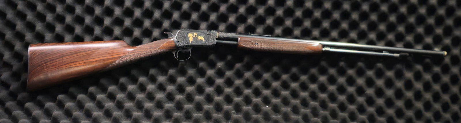 Winchester Model 62A Slide-action .22 S/L/LR Rifle: Winchester Model 62A slide-action rifle in .22 S/L/LR. High grade. SN 267932. New Haven manufacture, heavily custom-engraved with full coverage scrollwork and gold-inlaid game scenes including buffalo