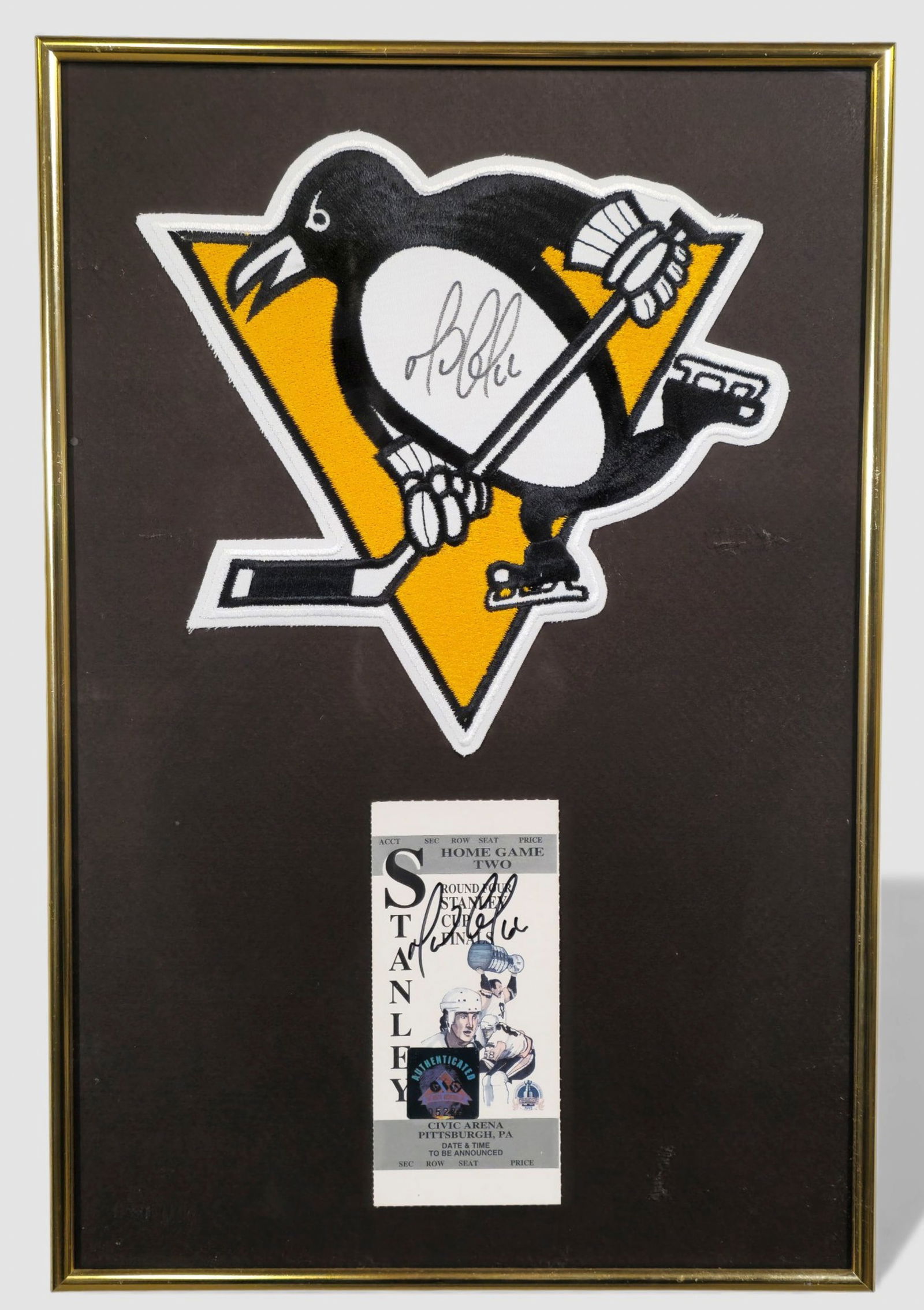 Mario Lemieux Signed Pittsburgh Penguins Patch & Stanley Cup Finals Ticket: Framed display featuring an authenticated hand-signed Pittsburgh Penguins logo patch and hand-signed Stanley Cup Finals home game ticket, both autographed by NHL legend Mario Lemieux (b. 1965). Presen