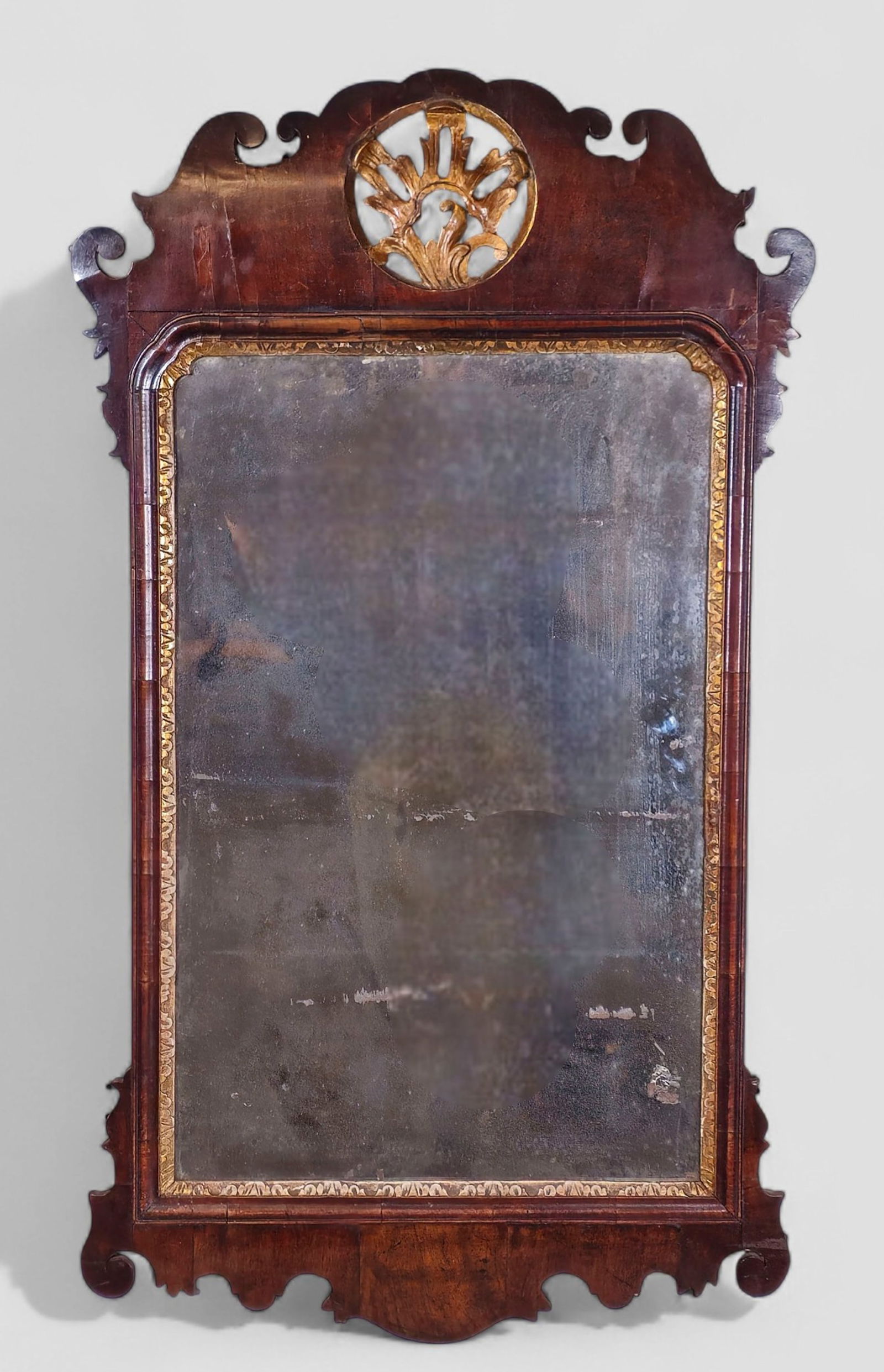 18th Century Mahogany & Giltwood Georgian Mirror: 18th Century Mahogany & Giltwood Georgian Mirror. Circa 1770-1790. Elaborate fret work mahogany frame. Gilded gesso slip and gilded motif to center. 24w x 2d x 42 1/2h.