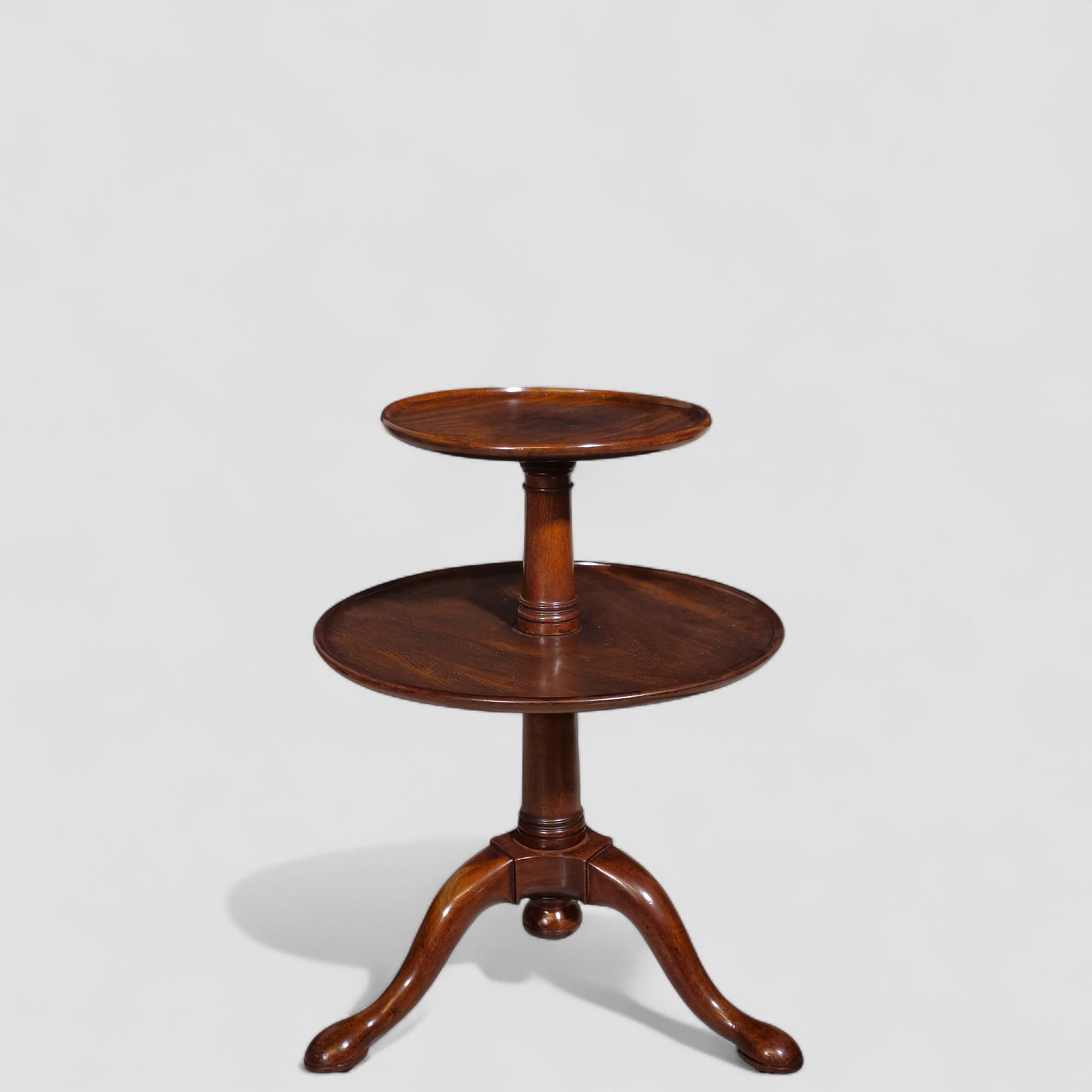 Early 19th Century Two Tier Mahogany Revolving Dumbwaiter: Early 19th Century Two Tier Mahogany Revolving Dumbwaiter Round top and lower revolving shelf. Turned support, cabriole legs and Queen Anne feet. Table rests on casters. 23 dia x 31h. Top - 15 1/2dia.