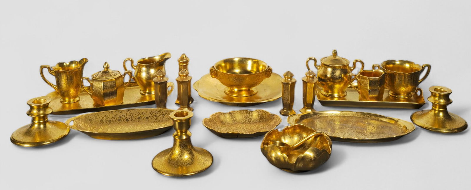 Assembled Pickard Gilt Porcelain Gold Tableware: Assembled Pickard Gilt Porcelain Gold Tableware. 24 pieces total. Circa 1920-1940s. 4 trays, 2 creamers, 3 sugars, candlestick, salt, scalloped nut bowl, double handled candy tray, scalloped bowl