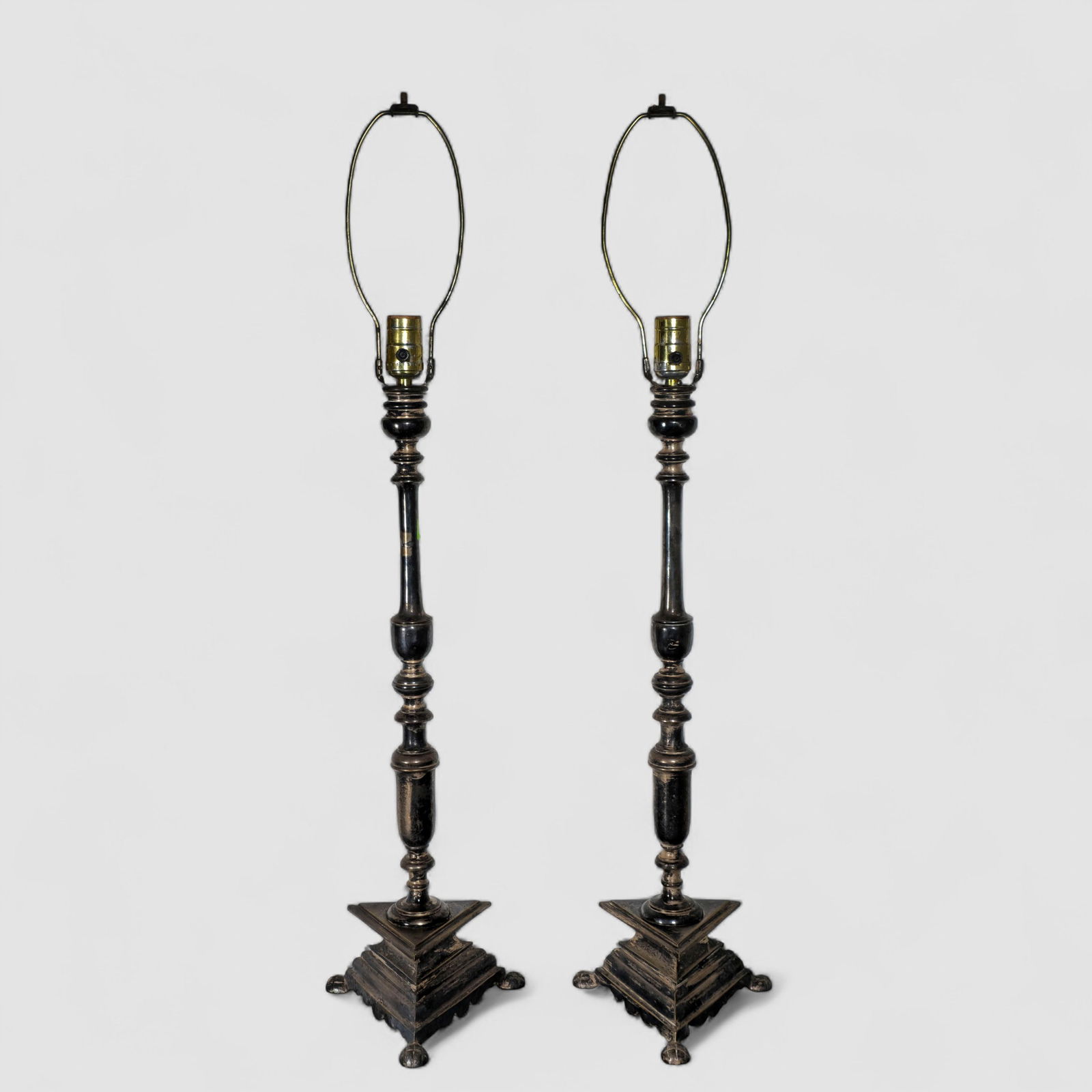 Dutch Colonial Style Silver Over Bronze Table Lamps: Dutch Colonial Style Silver Over Bronze Table Lamps. Pair. Early 20th century. Applied patina. Turned shaft over an triangular base resting on pineapple feet. 7 7/8w x 7 7/8d x 34h.